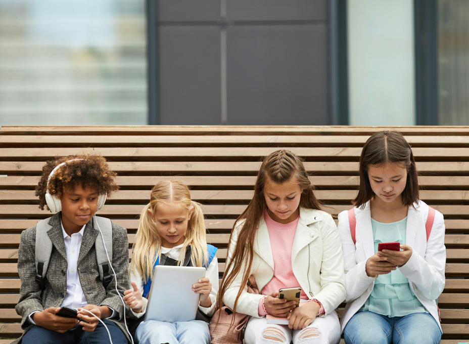 Teens and children looking at screens