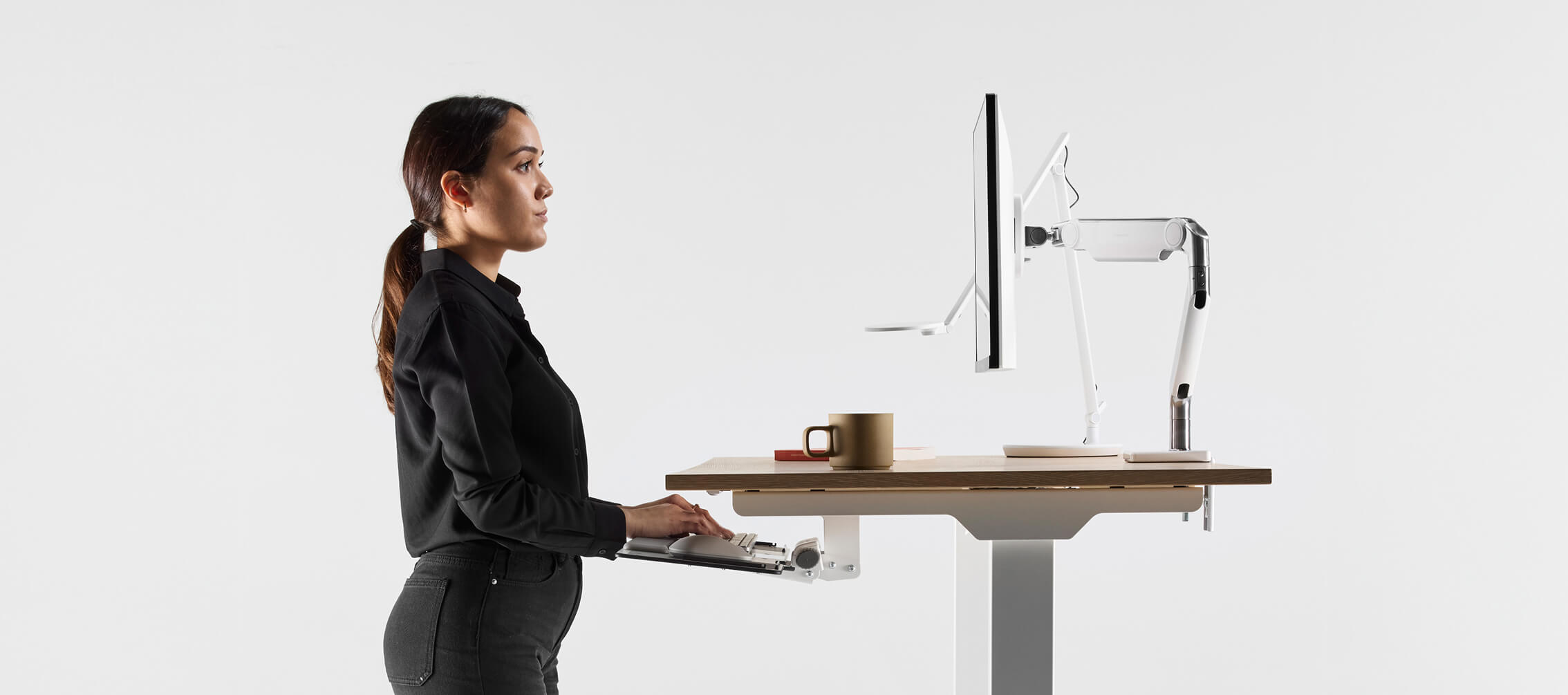 woman having her monitor adjusted for peak ergonomics