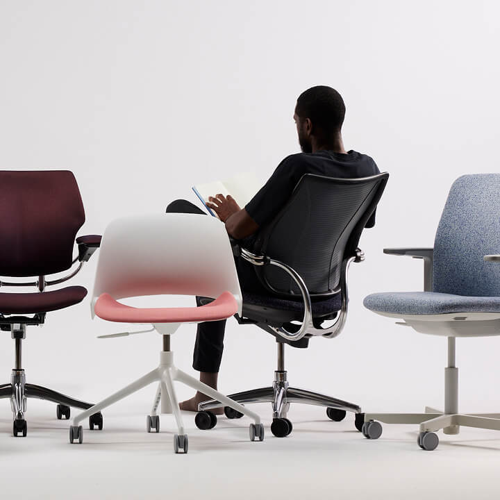 Man sitting in a Liberty chair, with other chairs surrounding him.