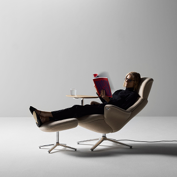 Individual reading on the Humanscale Diffrient Lounge with ottoman